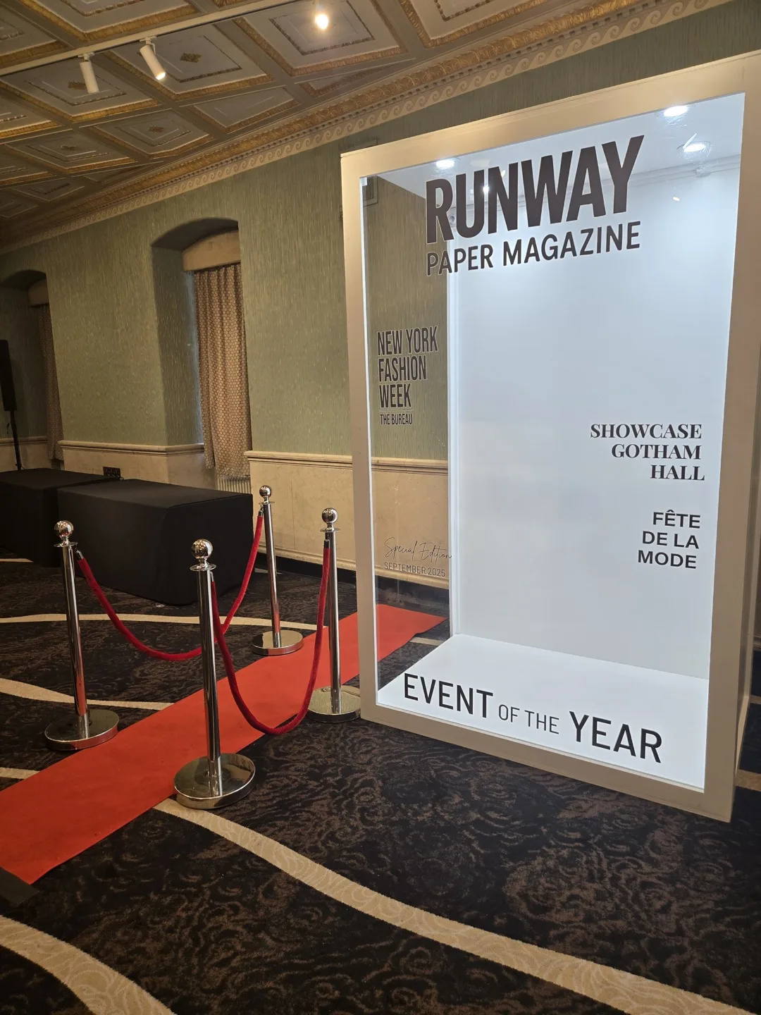 Runway Paper Magazine cover booth with red carpet and stanchions at Gotham Hall during New York Fashion Week