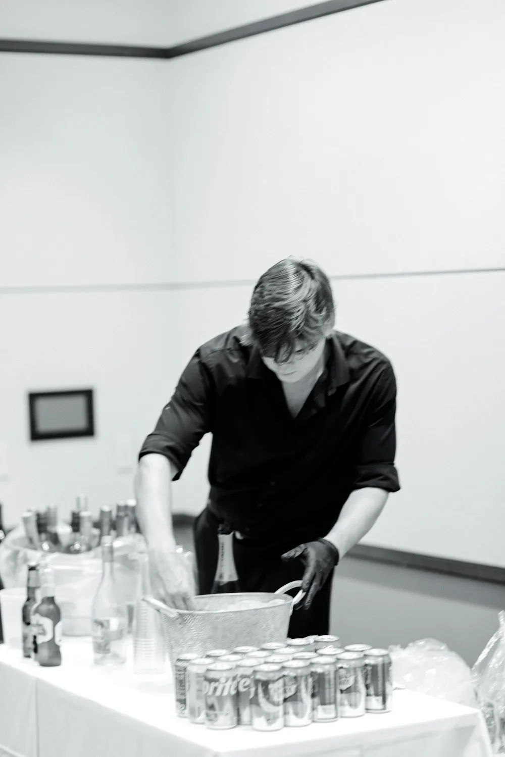 Black and white photo of a bartender pouring drinks at a corporate event in NYC