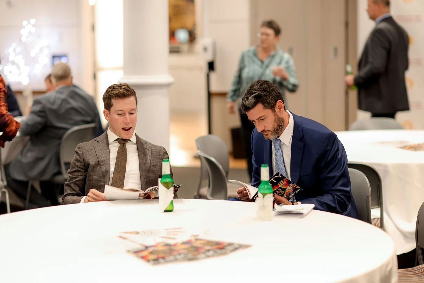Candid corporate event photography in NYC: two guests laughing at an awards gala table