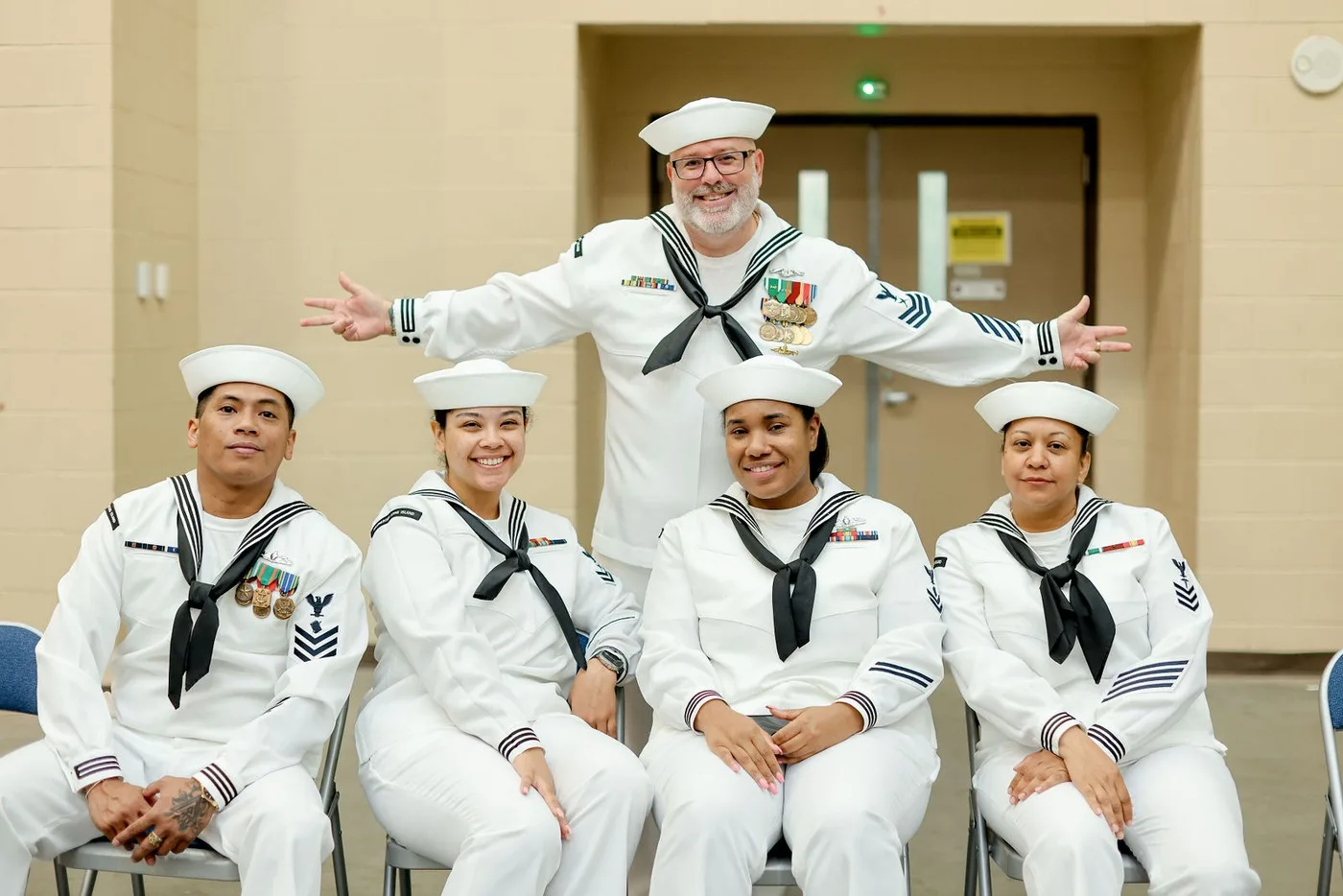 Group photo of sailors in dress uniform at a Navy ceremony