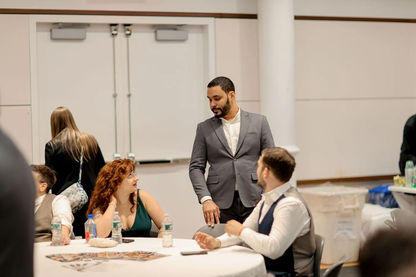 Event host greeting seated guests at a corporate awards gala in New York