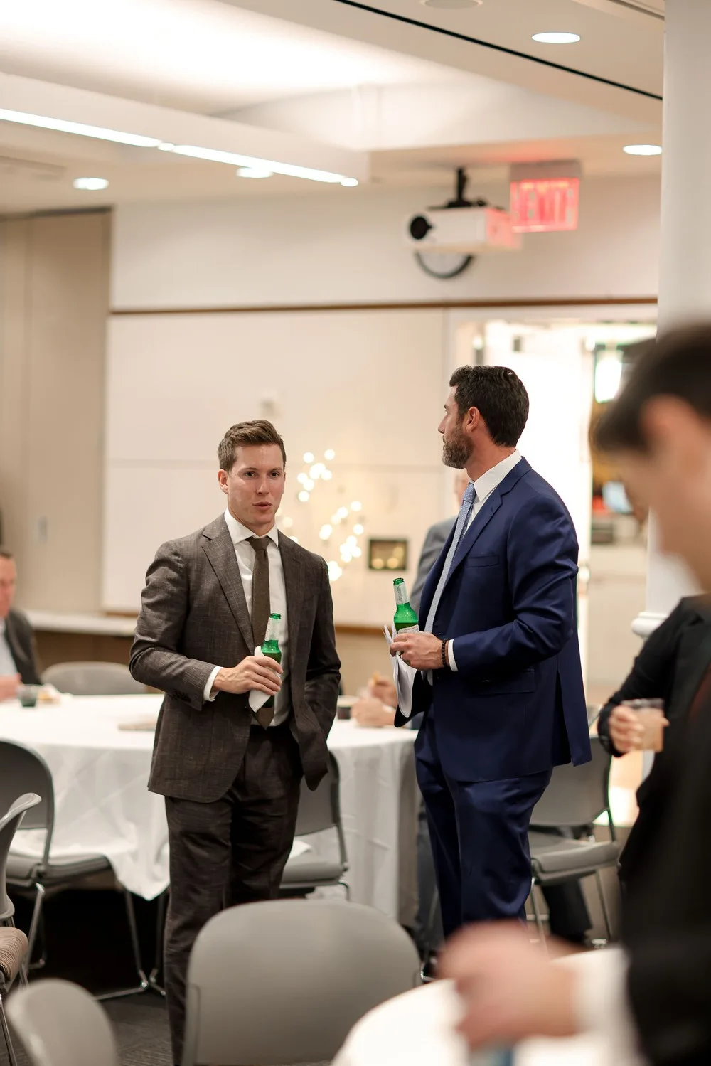 Two executives networking with drinks at an NYC corporate awards gala