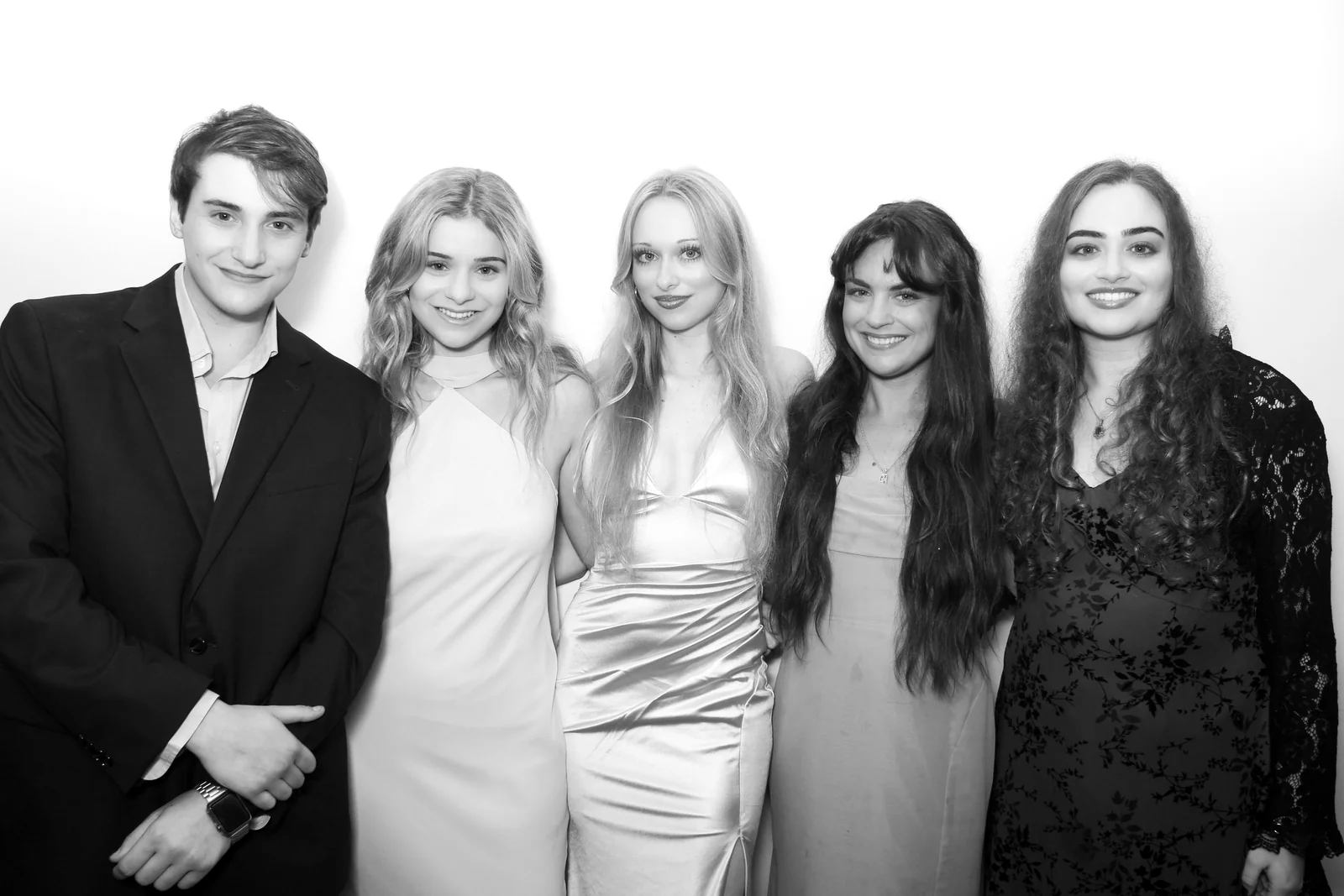 Glam photo booth rental NYC — black and white group portrait of five guests in formal wear against a white backdrop