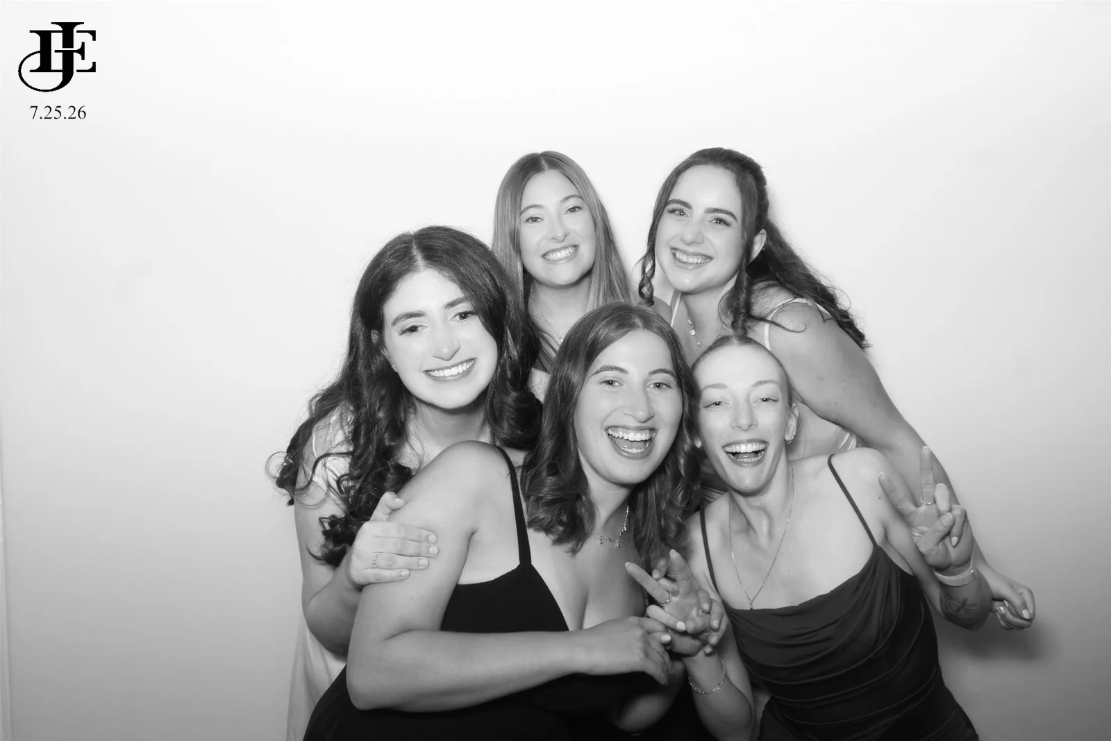 Glam photo booth rental NYC — black and white portrait of five friends laughing in the glam booth
