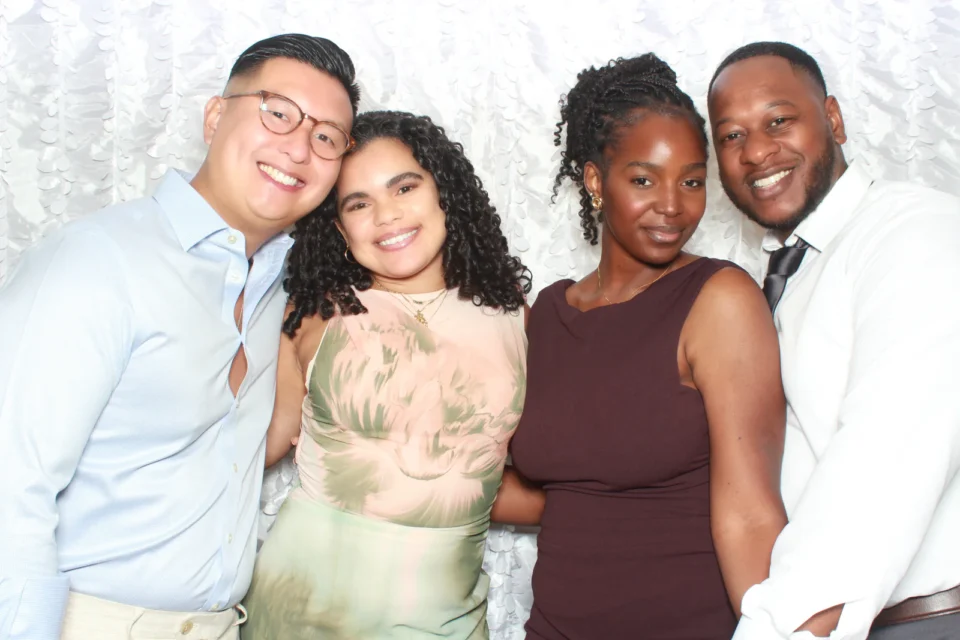 Open air photo booth rental NYC — four guests at a white textured leaf backdrop