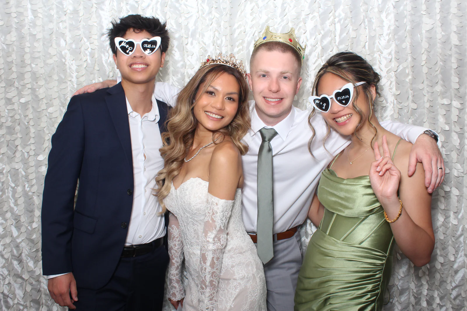 Wedding photo booth rental NYC — bride and groom with guests wearing custom heart sunglasses