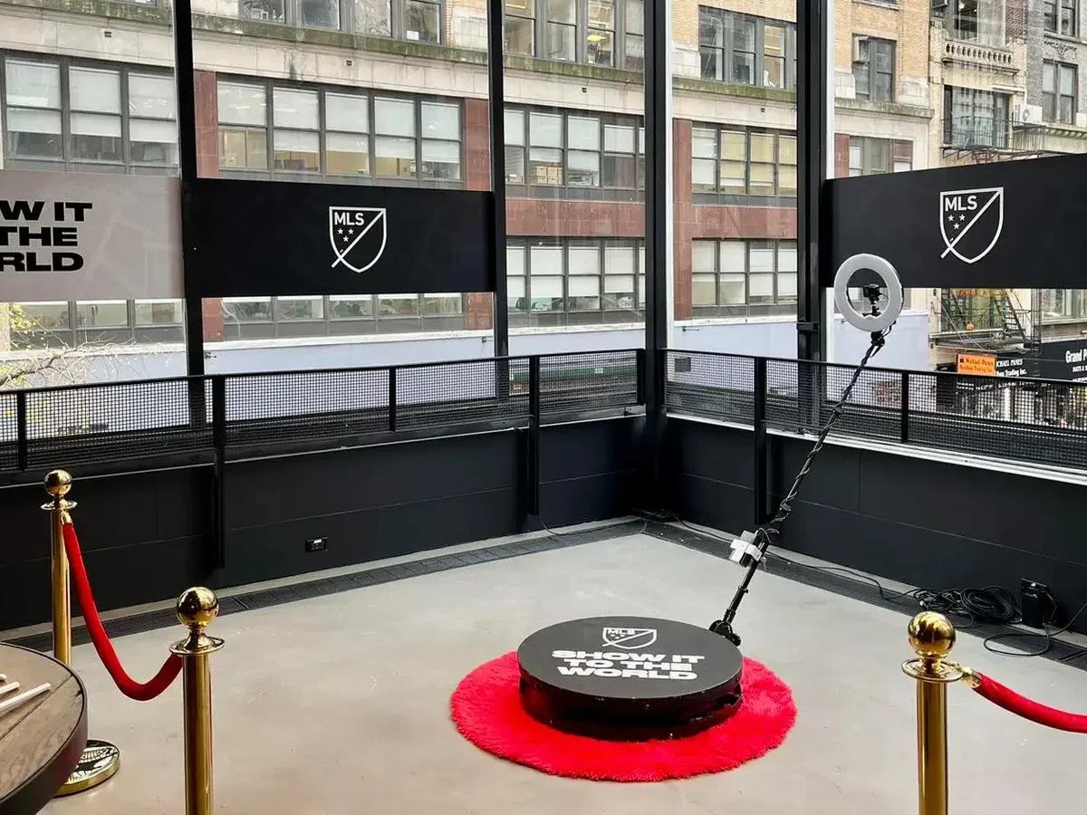 360 photo booth rental NYC: slow-motion 360 video booth with red carpet and stanchions on a Manhattan rooftop at an MLS event